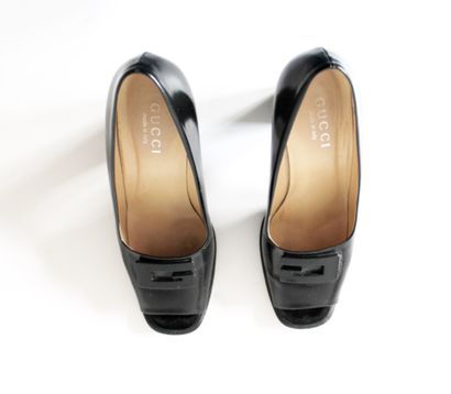 null GUCCI, Pair of black patent leather heels open at the front and adorned with...