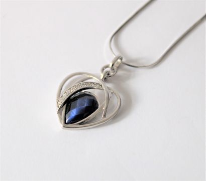 null Heart-shaped pendant adorned with a blue stone and a line of rhinestones, on...