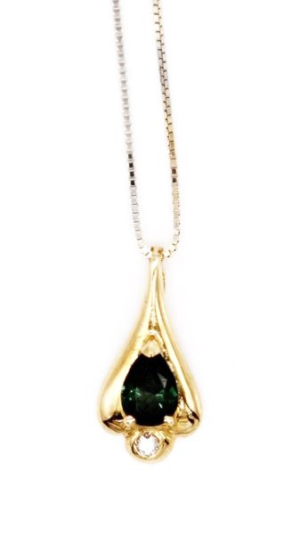 null *750 yellow gold pendant set with a green tourmaline flanked by a small brilliant-cut...