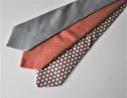 null HERMES, Three silk ties with different designs in orange, grey and blue ton...