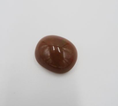 null Opal cabochon cut in cushion with red-brown reflections dotted with green. Possible...