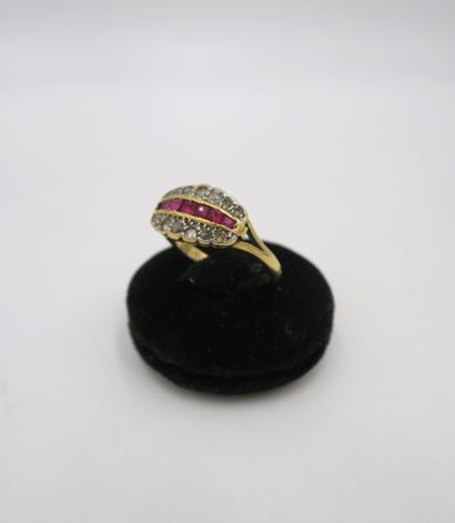 null Antique ring in 18K yellow gold, set with a line of calibrated red stones, shouldered...