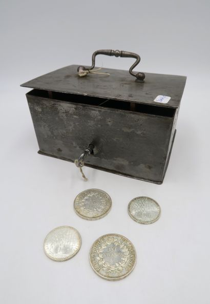 null In a metal box with key:
2 silver coins of 10 and 100 francs