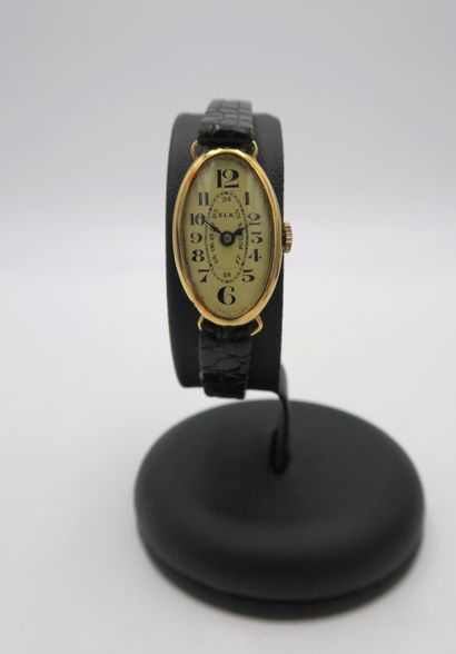 null ELK
Ladies' wristwatch with oval case in 18K yellow gold, gold dial with black...