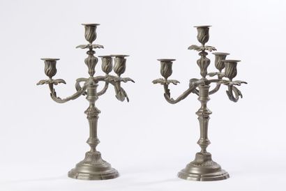 null A pair of four-light candelabra in silver plated bronze. The shaft in fluted...
