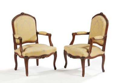 null Pair of moulded and carved wooden armchairs, armrests with cuffs, curved legs...