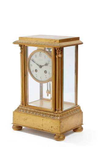 null J. AURICOSTE 

Gilt bronze cage clock decorated with friezes of stripes and...