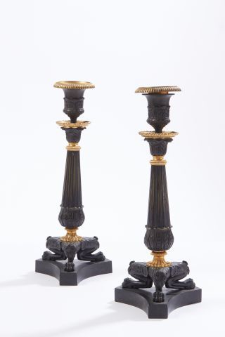 null Pair of bronze torches with a double black and gold patina, the fluted shaft...