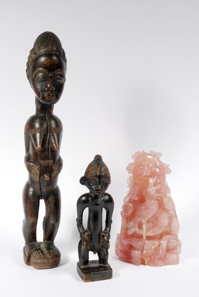 null Set including : 



Male figure in blackened wood represented standing with...
