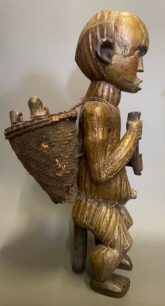 null Collector of souls 

Wooden sculpture covered with brass leaves and wicker basket...
