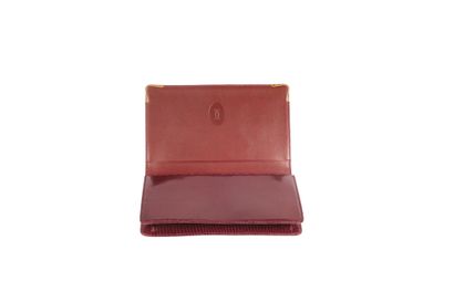 null * CARTIER 

Clutch bag in burgundy glossy lizard, inside box decorated with...