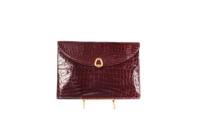 null * Christian DIOR 

Circa 1970 

Clutch bag in burgundy glossy estuary crocodile,...