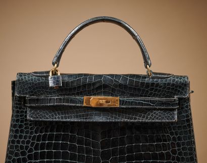 null Hermès Paris (1959)
32 cm "Kelly" bag in lustrous midnight-blue Estuaire crocodile,...