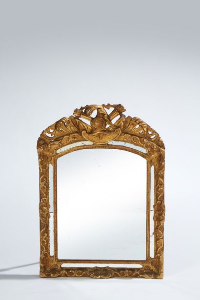 null Gilded wood and stucco mirror with glazing beads, the pediment topped by a helmet...