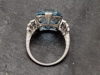 null Platinum ring set with a recently cut but intense blue aquamarine on a stepped...
