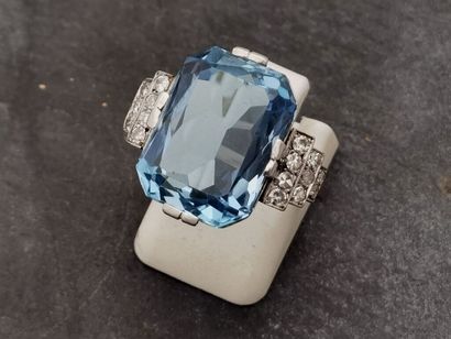 null Platinum ring set with a recently cut but intense blue aquamarine on a stepped...