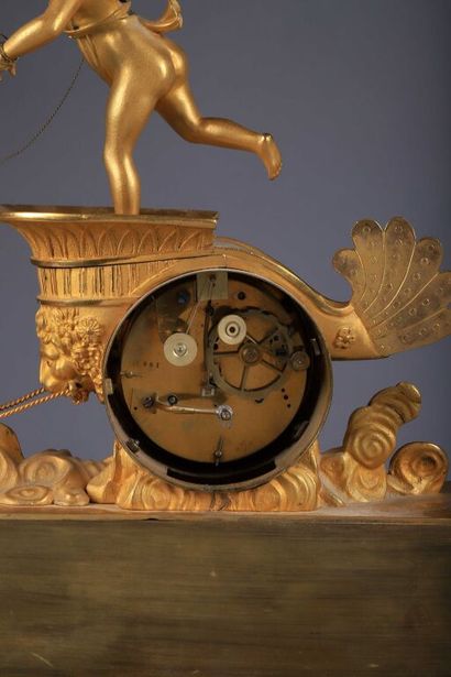 null Chased and gilded bronze clock representing a winged love driving his chariot,...