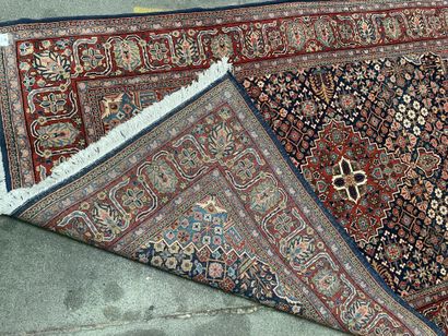 null Pair of woolen rugs with polychrome decoration of stylized floral motifs on...