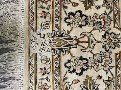 null Silk carpet with polychrome decoration of floral motifs on an off-white background.

Bears...