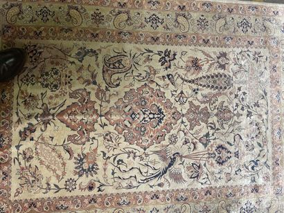 null Silk carpet with polychrome decoration of stylized floral motifs and birds.

20th...