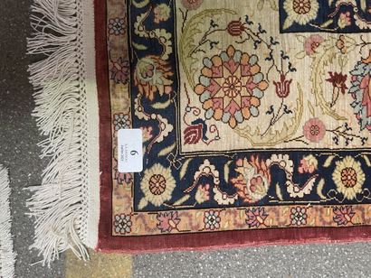 null Polychrome silk carpet decorated with floral motifs on a red background.

Bears...