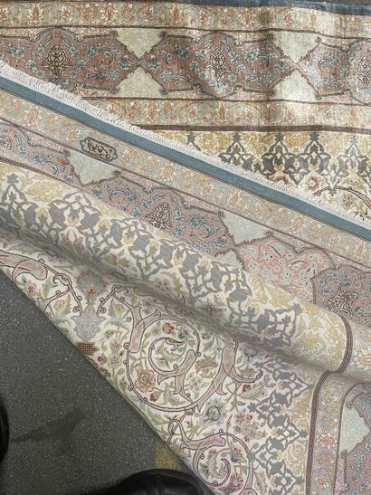 null Silk carpet with polychrome decoration of scrolls and stylized motifs on a beige...