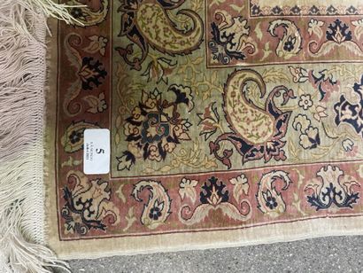 null Silk carpet with polychrome decoration of stylized floral motifs and birds.

20th...