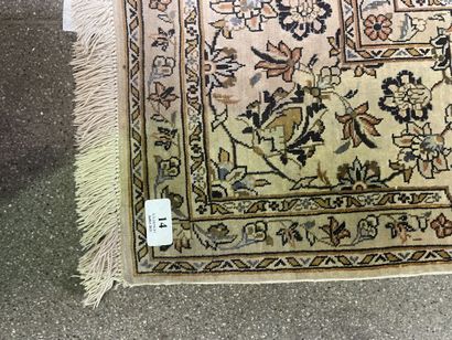 null Silk carpet with polychrome decoration of floral motifs on an off-white background.

Bears...