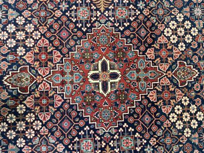 null Pair of woolen rugs with polychrome decoration of stylized floral motifs on...