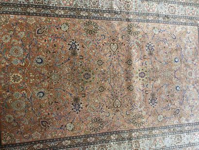 null Silk carpet with polychrome floral decoration on a red background.

Bears a...