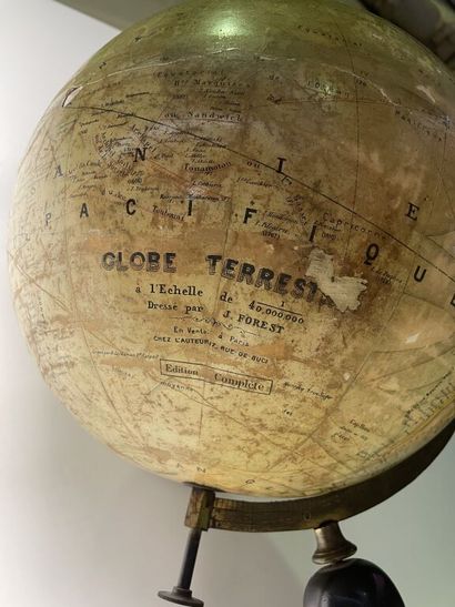 null Globe in plaster covered with a lithography posing on a support in blackened...