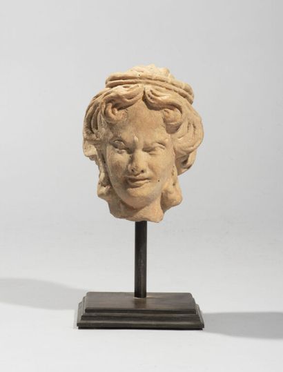 null In the style of GANDHARA.

Head of a terracotta deity with curly hair, base.

H....