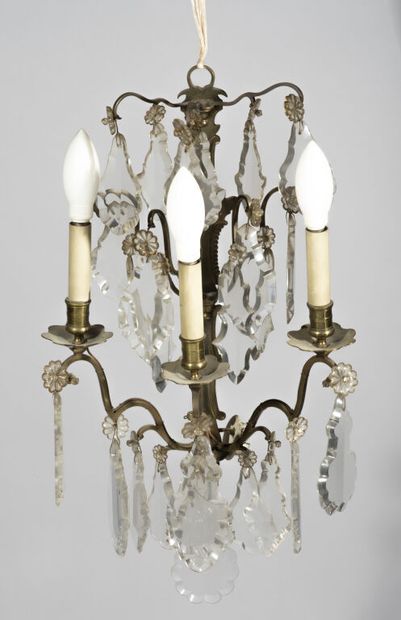  Suite of four sconces in patinated brass with three arms of light, decorated with...