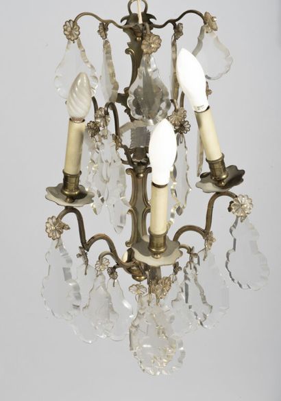  Suite of four sconces in patinated brass with three arms of light, decorated with...