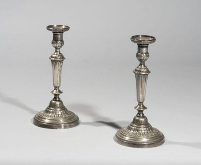 null Pair of torches in re-silvered bronze, the circular bell decorated with flutes...