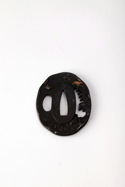 null JAPAN.

Black patina iron oval tsuba with engraved, chiseled, openwork and inlaid...