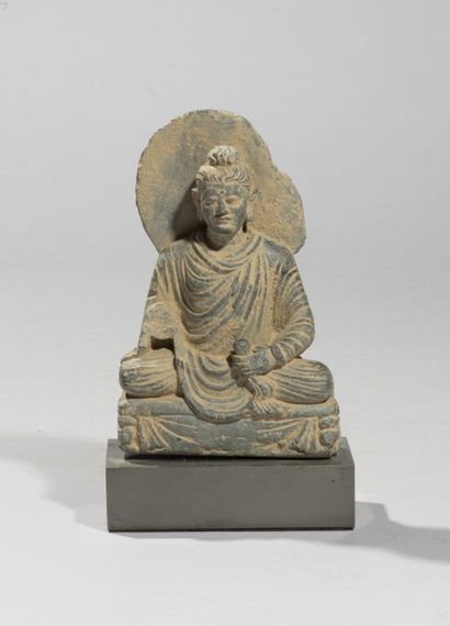 null In the style of GANDHARA.

Statue of a haloed Buddha in grey schist, represented...