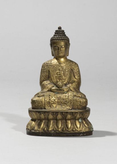 null CHINA.

Statuette of Buddha in gilded bronze, represented sitting on a lotiform...