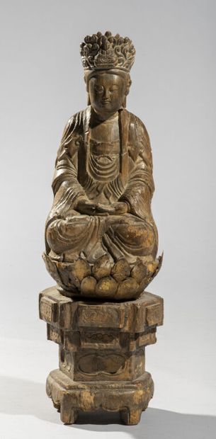 null CHINA.

Wooden statue of a bodhisattva, represented seated on a lotus supported...