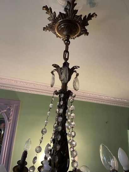 null Chandelier with twelve chased and gilded bronze arms of light, decorated with...