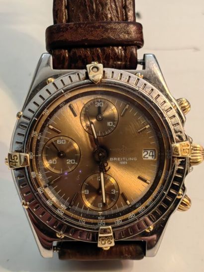 null BREITLING. CHRONOGRAPHE-BRACELET en or 750 mm et acier, cadran champagne à trois...