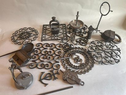 null Wrought iron set including seven trivets, display stands, hooks, stamp, corkscrew...