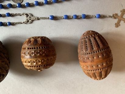 null Two eggs in carved corozo (one containing a rosary) and a wooden egg carved...