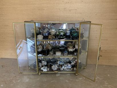 null Small gilded brass and glass display case with three levels filled with miniature...