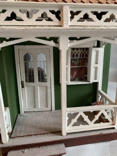 null Antique toy.

Important dollhouse in painted wood and natural wood consisting...