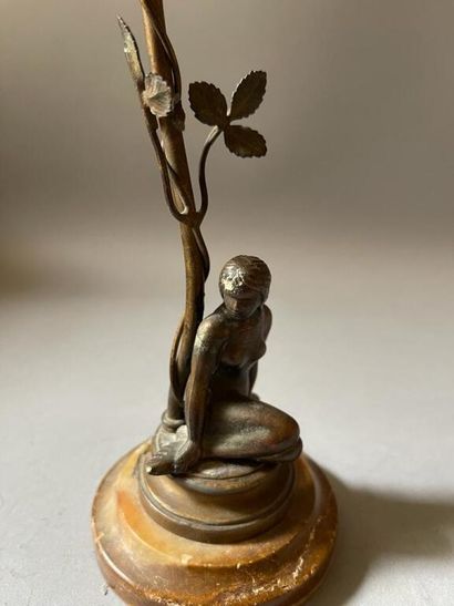 null Small lamp in patinated metal representing at its base a naked woman, crouching.

In...