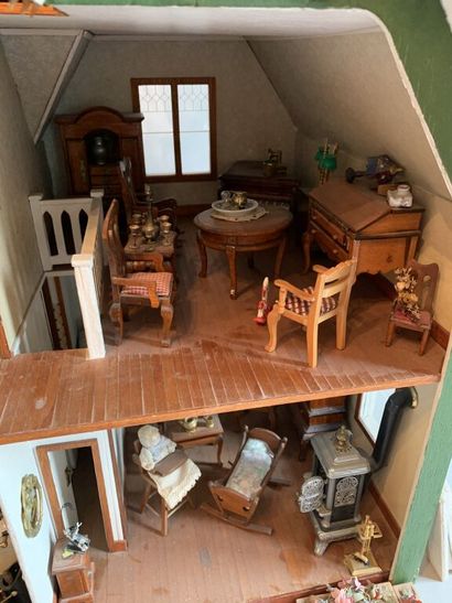 null Antique toy.

Important dollhouse in painted wood and natural wood consisting...