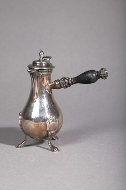 null Small silver coffee pot (950/1000th) resting on three feet. The side handle...