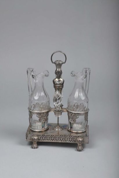null Oil and vinegar holder in silver (950/1000th) composed of a large socket showing...