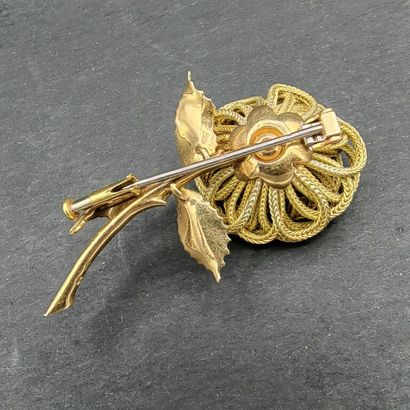 null A yellow gold 750 mm brooch showing a flower in passementerie threads, the pistil...